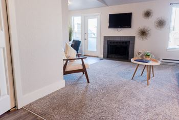 A living room with a fireplace and a television